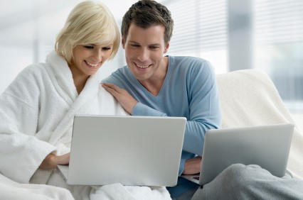 Couple looking at laptops.